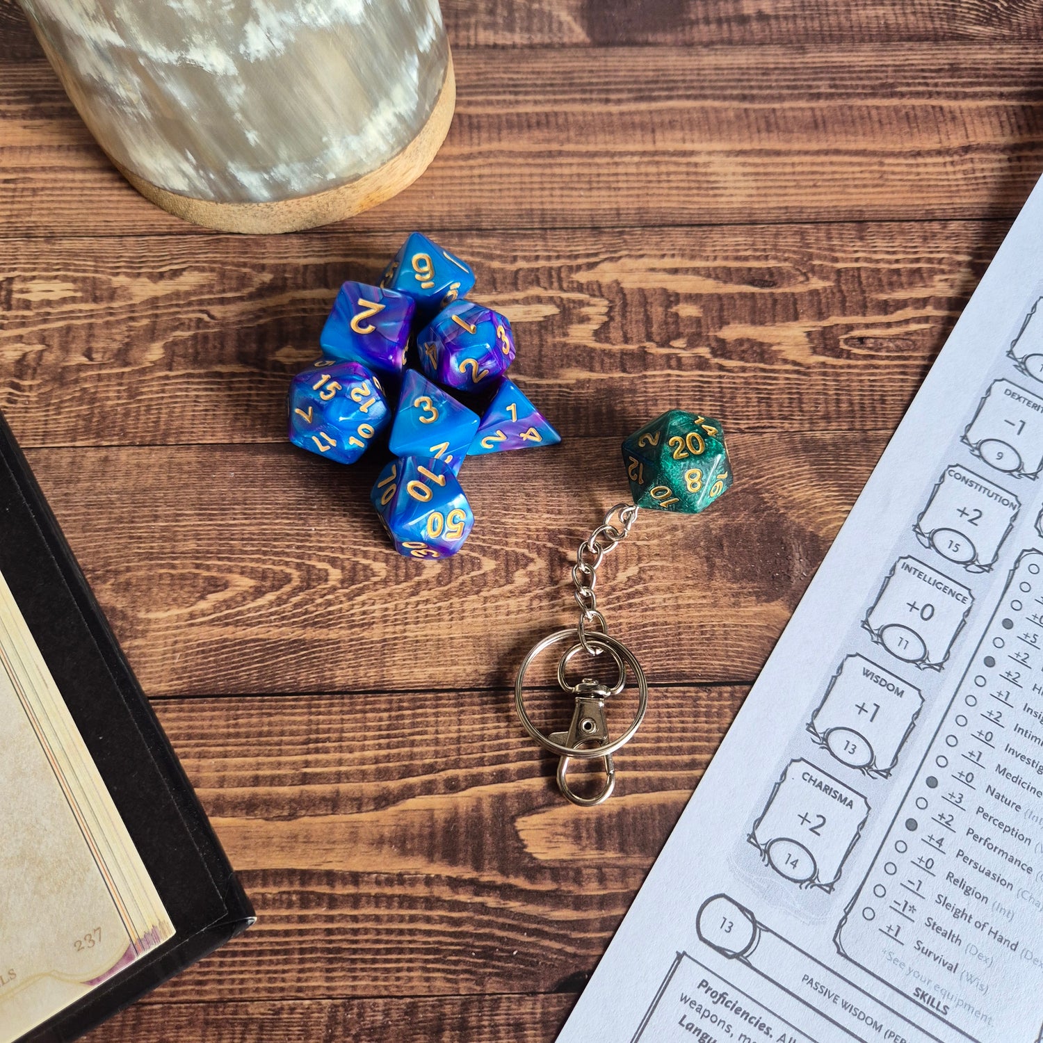 D20 dice and keychains with mystery dice sets on a wooden gaming table – Tabletop Gaming Accessories by Printed Fantasy NZ